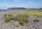 Hills rise rise up behind the stoney beach at Porlock Weir in Somerset, UK