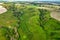 Hills slopes overgrown with green grass, nature reserve Ukrainian Iceland near Vasylkiv, Ukraine. Aerial view
