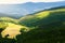 Hills and sunny valley in the Stone Mountains. Vast panorama of picturesque countryside landscape in Sudetes, Poland. Aerial view.