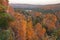 Hills trees and a small lake surrounded by trees in autumn color at sunrise in northern Minnesota