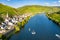 Hills with vineyards and church in Merl village of Zell Mosel town, Rhineland-Palatinate, Germany. Water skiing, barges