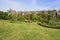 Hillside grassy lawn before European style houses in sunny autumn