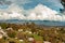 Hillside homes mountain range with huge cumulus nimbus clouds