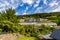 Hillside houses in Frankton near Queenstown New Zealand surrounded by great blue skyline and lush vegetation.