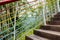 Hillside planked stairway with colorful steel handrail