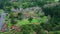 Hillside roadway running forest nature drone view. Gloomy weather green fields