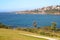 Hillside town on waterfront. Picturesque and amazing landscape with grass, shrubs and metal fences on by sea in Sydney, Australia