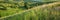 Hillsides covered with dry feather grass, rural landscape. Web banner