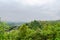 Hilltop stone wall and hill foot town in cloudy spring afternoon