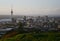 Hilltop vista of coastal cityscape of cbd and Sky Tower from Mount Eden with lush vegetation before sunset, Auckland, New Zealand