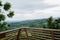 Hilltop wooden railing in cloudy windy summer afternoon