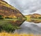 Hilly coast reflected in the water