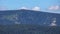 Hilly forested landscape with rock formation on the top of a ridge - Vozka mountain