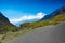 Hilly highway with green pasture and blue sky on the way to himalaya from the road,manali tourism Himachal leh ladakh, India