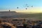 Hilly landscape and balloon at sunset. Balloons. Goreme, Cappadocia - Landmark attraction in Turkey