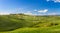 Hilly landscape with blue skies in Crete Senesi, Asciano, Siena, Italy