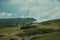 Hilly landscape with clouds coming up the ravine