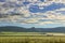 Hilly landscape with corn field immature dominated by clouds: Alta Murgia National Park, Apulia Italy.