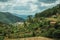 Hilly landscape covered by rocks and trees with rustic houses