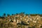 Hilly landscape covered by rocks and trees on sunset