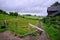 Hilly landscape, limburg the netherlands, green meadow with hay bales, in the foreground a wooden fence with signs with