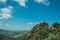 Hilly landscape with tower of castle over rocky cliff