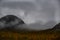 hilly mountains overgrown with autumn colorful forest and foggy haze.