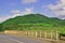 Hilly Road with Barrier and mountainous background around Mahebourg, Mauritius