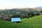 Hilly summer landscape with a hut at the forefront