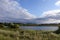 Hilly summer landscape with river and wild herbs