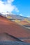 Hilly volcanic landscape around the top of famous Mount Etna, Sicily, Italy. Snow on the very top of the mountain