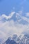 Himalaya Machapuchare mountain peak in cloudy blue sky, Nepal