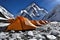 Himalayan Orange Tents are pitched on rocky ground covered with snow