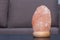 Himalayan pink salt lamp on table indoors