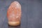 Himalayan pink salt lamp on table indoors