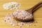 Himalayan sea salt on a wooden spoon and oatmeal