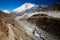 Himalayas mountain landscape. A steep snowy peak and a vast valley on a beautiful sunny day.