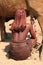 Himba woman is milking a cow