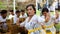 Hindu celebration at Bali Indonesia, religious ceremony with yellow and white colors, woman dancing.