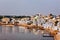 Hindu devotees bathing in sacred Puskhar Sagar lake on on ghats of Pushkar, Rajasthan, India