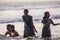 Hindu family do holy bathe at the sacred confluence on Papanasam beach