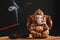 Hindu god Ganesh on a black background. Rudraksha statue and rosary on a wooden table with a red incense stick and incense smoke
