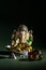 Hindu God Ganesha. Ganesha Idol. A colorful statue of Ganesha Idol on dark background. space for text or headline