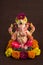 Hindu God Ganesha. Ganesha Idol on dark wooden background