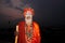 Hindu monk whose face smeared with ash stands in the ghats of the river Ganges