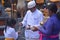 Hindu priest blessing Balinese family celebrating Galungan Kuningan holidays in Bali Indonesia