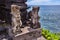 Hindu statue near enter to a sacred place. Bali island.