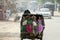 Hindu Women in India Ride a Three Wheel Taxi