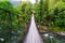 A hinged wooden bridge across the river.