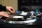 Hip hop dj scratching vinyl record disc on turn table player in close up